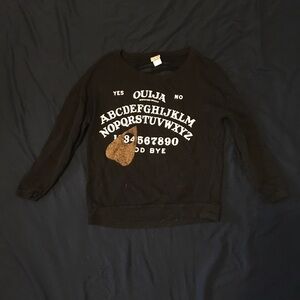 Ouija board sweater with cut open back